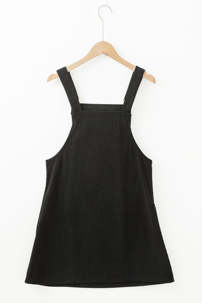 Chic black sleeveless corduroy overall dress with front pockets