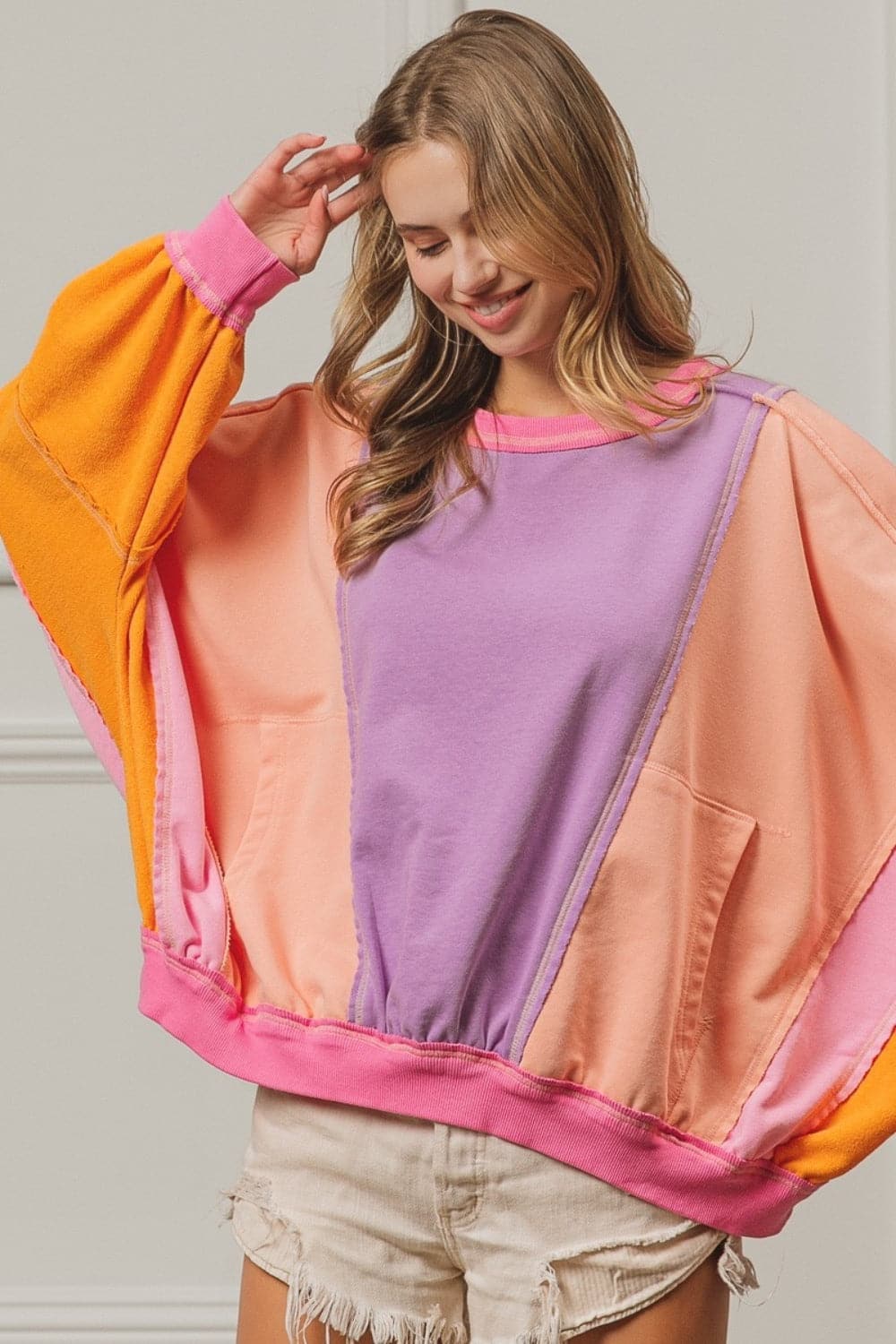 BiBi Color Block Exposed Seam Sweatshirt with Pockets.