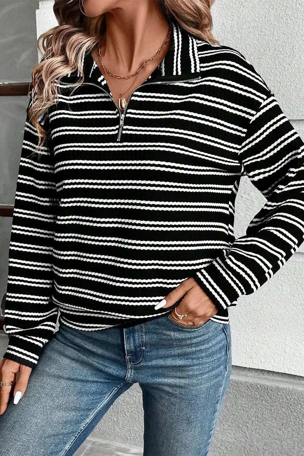 Striped half zip long sleeve top in black and white with jeans.