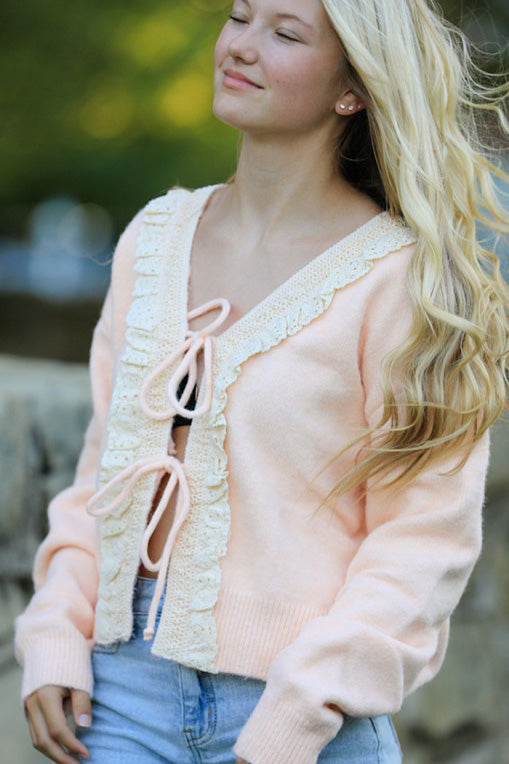 Miss Sparkling Cardigan with ruffled trim, front tie. Soft knit cardigan in a stylish, comfortable design.