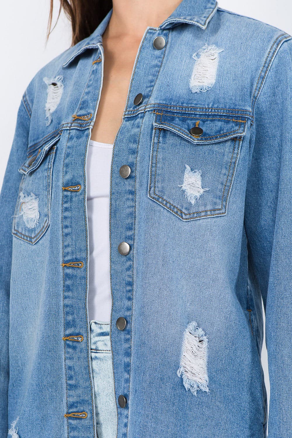 Distressed denim jacket with frayed hem for a vintage vibe