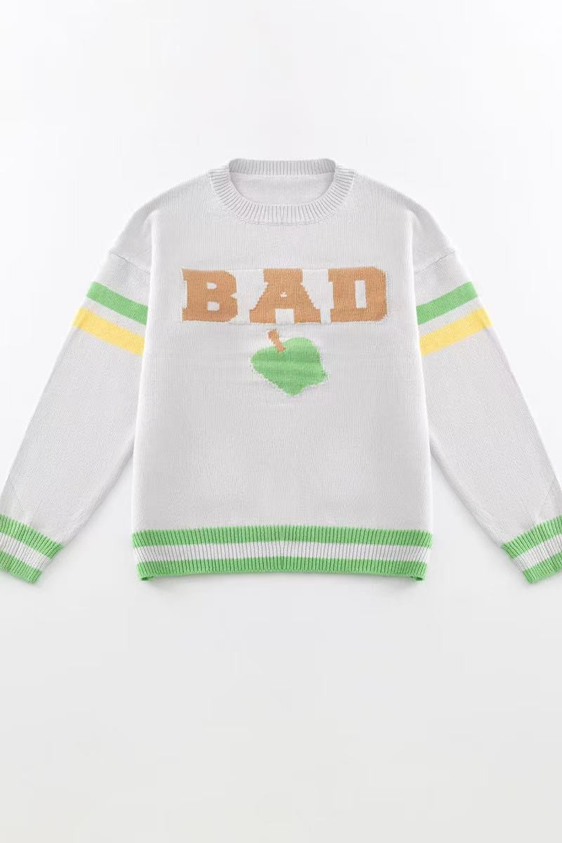 Close-up of the Miss Sparkling Bad Apple Sweater showing the soft knit texture and detailed apple embroidery.
