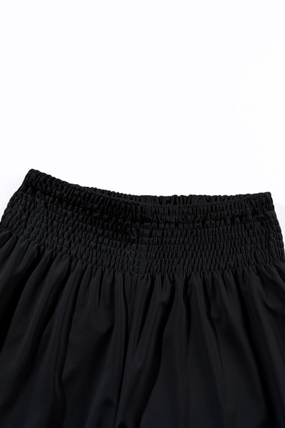 Chic black smocked high-rise joggers for a trendy look