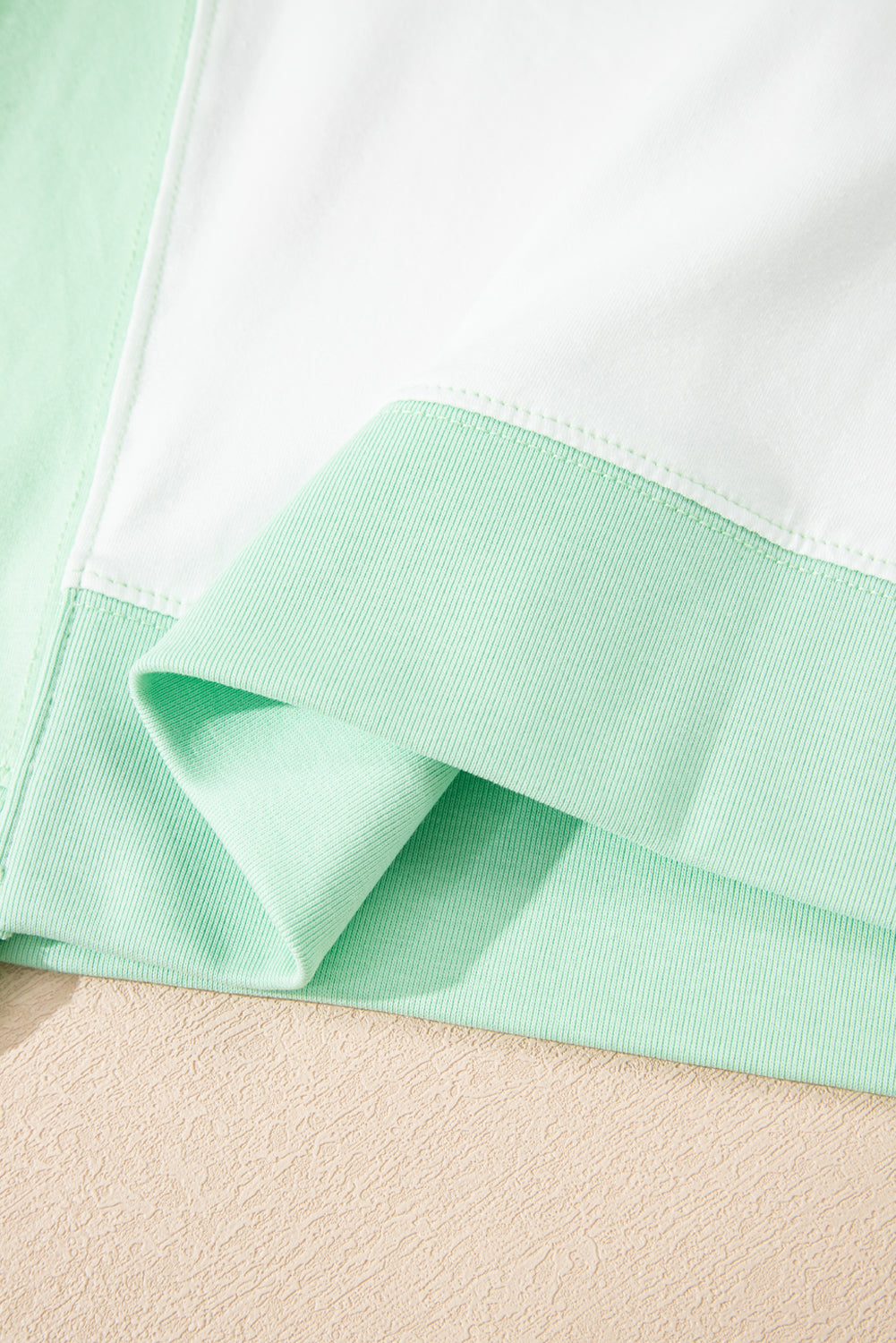 Light green color block exposed seam crew neck t-shirt.