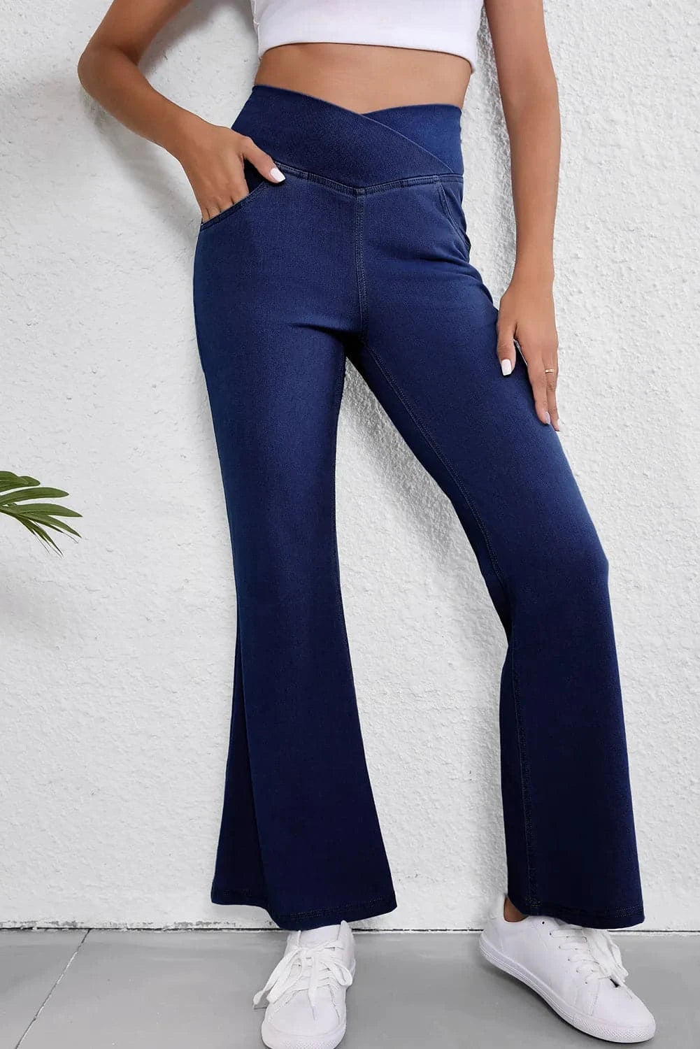 Asymmetric waist flare jeans with pocketed stretch and premium material.