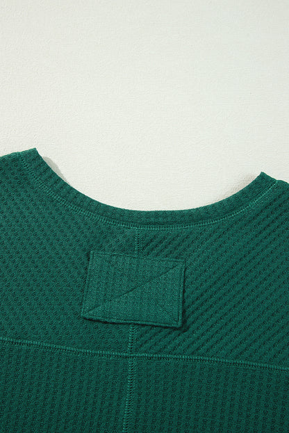 Chic blackish green waffle knit V-neck long sleeve blouse with drop shoulders