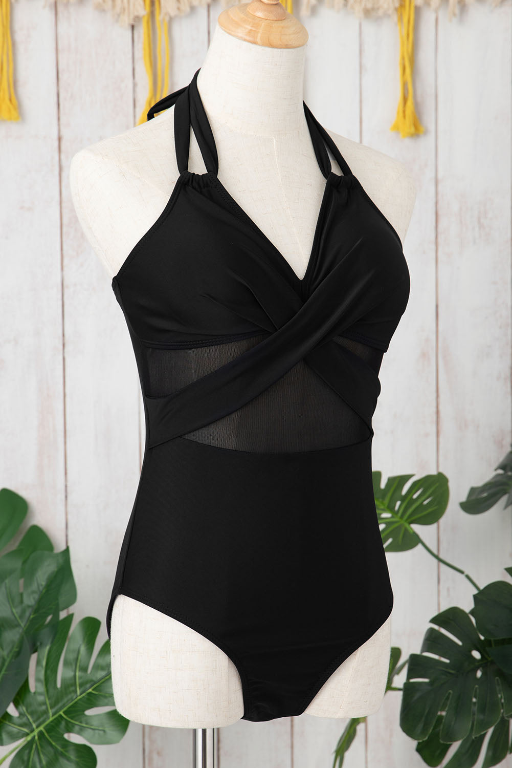 Elegant black halter one-piece swimsuit with mesh inserts