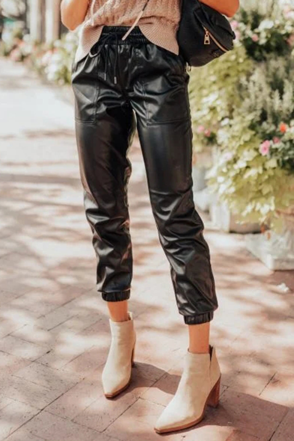 Chic black faux leather joggers with smocked waist and drawstring detail