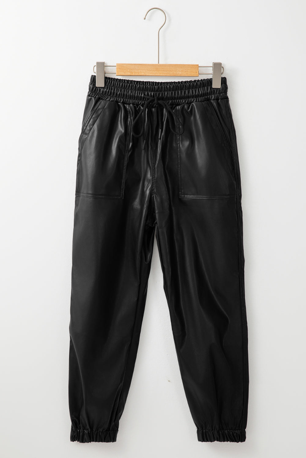 Chic black faux leather joggers with smocked waist and drawstring detail