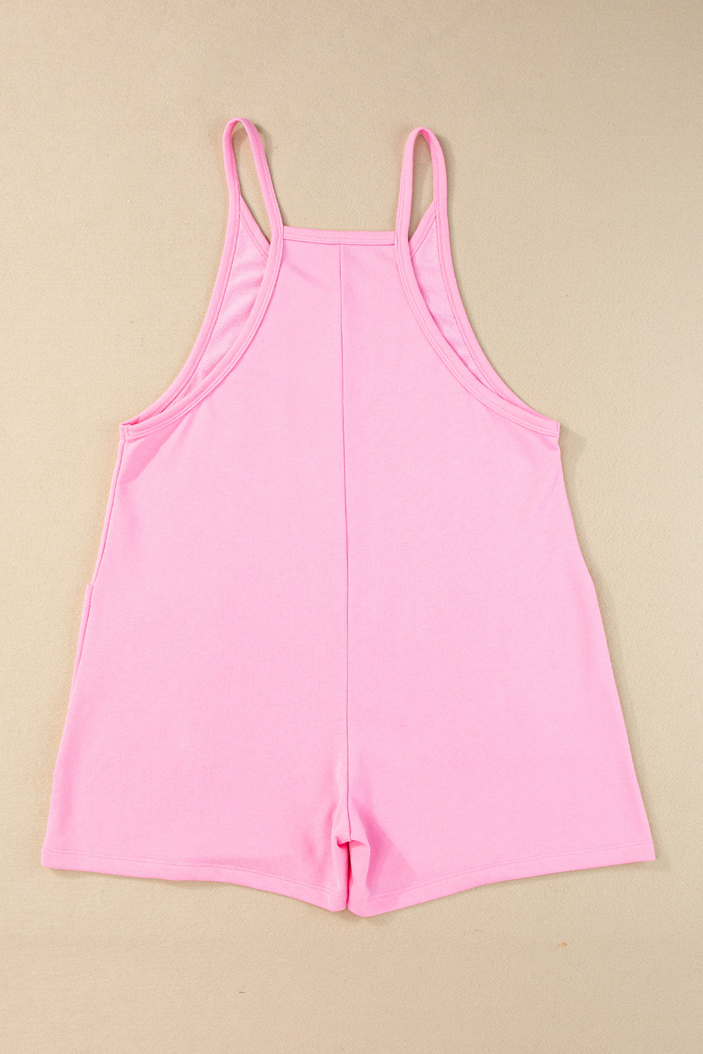 Chic pink sleeveless jersey romper with pockets and v-neck detail