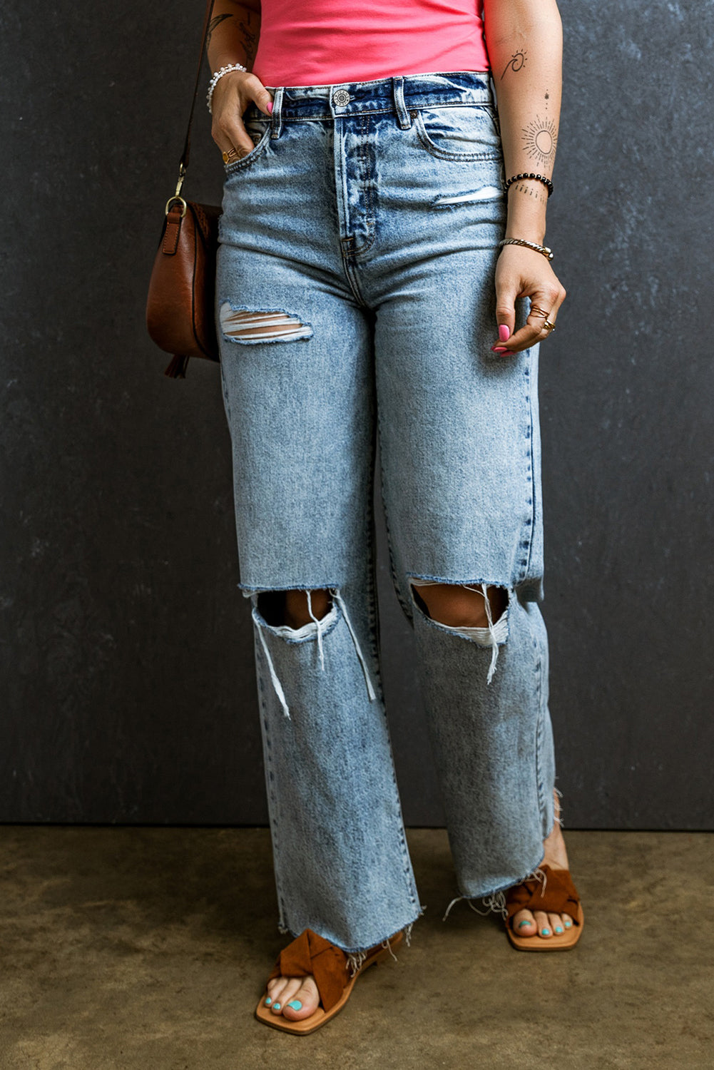 Trendy light blue distressed straight leg jeans with raw hem