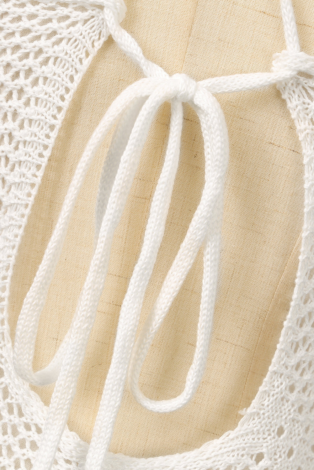 Elegant white beach dress with crisscross back and tassel details