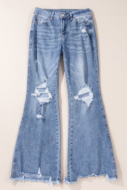 Dusk blue high-waisted flared jeans with distressed hem and ripped details