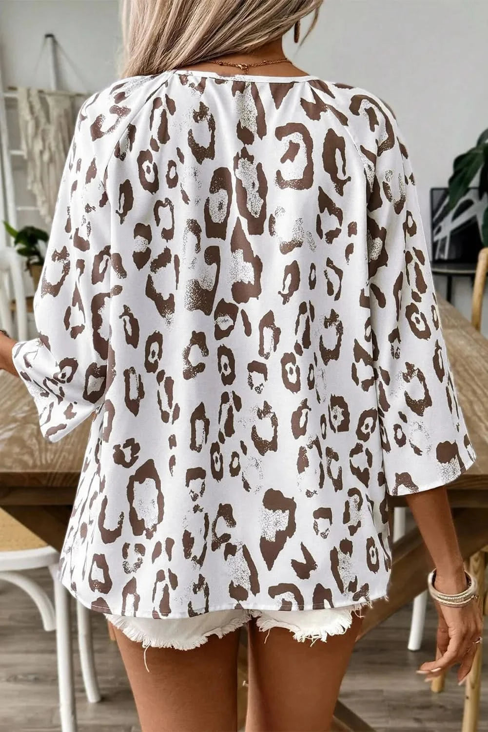 Leopard-print v-neck blouse with three-quarter sleeves