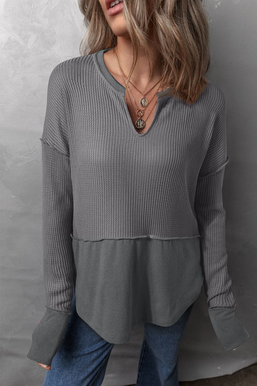 Waffle-Knit Exposed Seam Notched Long Sleeve Top.