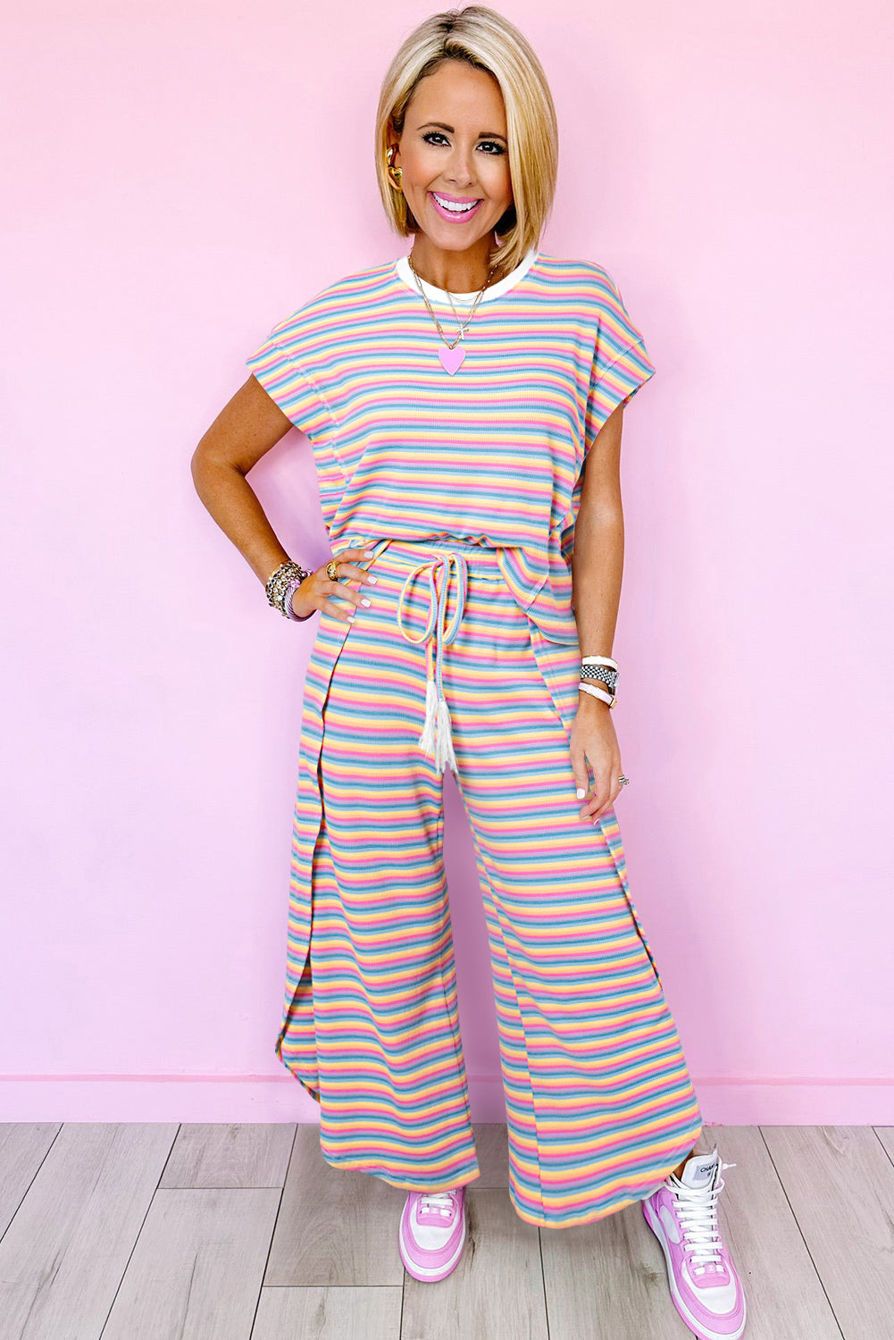 Chic pink striped rainbow tee and tasseled wide leg pants ensemble