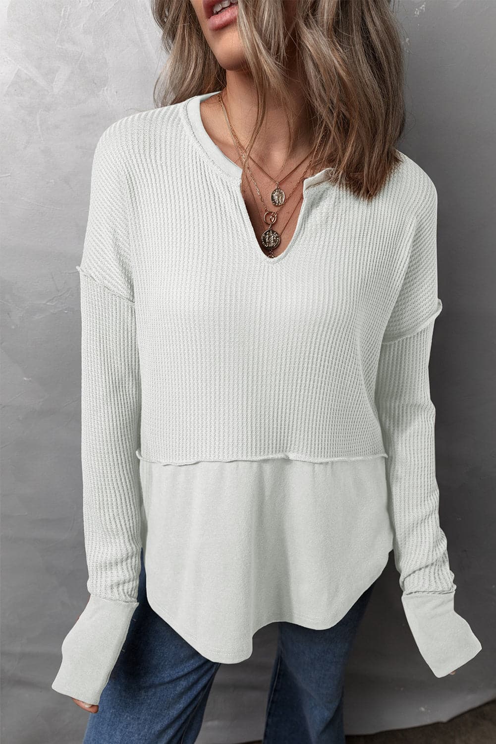 Waffle-Knit Exposed Seam Notched Long Sleeve Top.