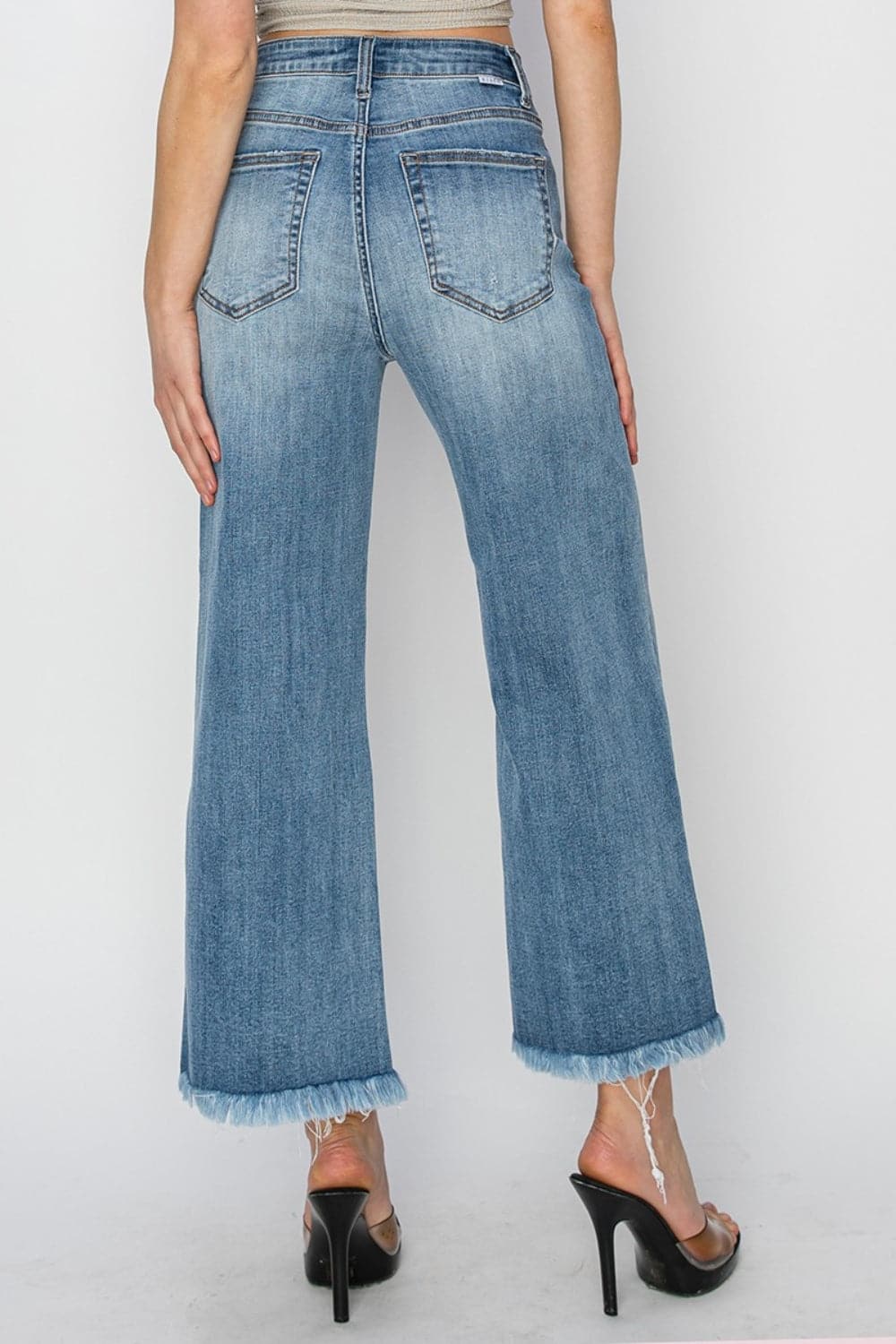 RISEN Raw Hem Cropped Wide Leg JeansHigh Rise Raw Hem Cropped Wide Leg Jeans are the perfect addition to your wardrobe. With their high rise fit, raw hem detail, and wide leg silhouette, these jeans ofLove Salve RISEN Raw Hem Cropped Wide Leg JeansJeans