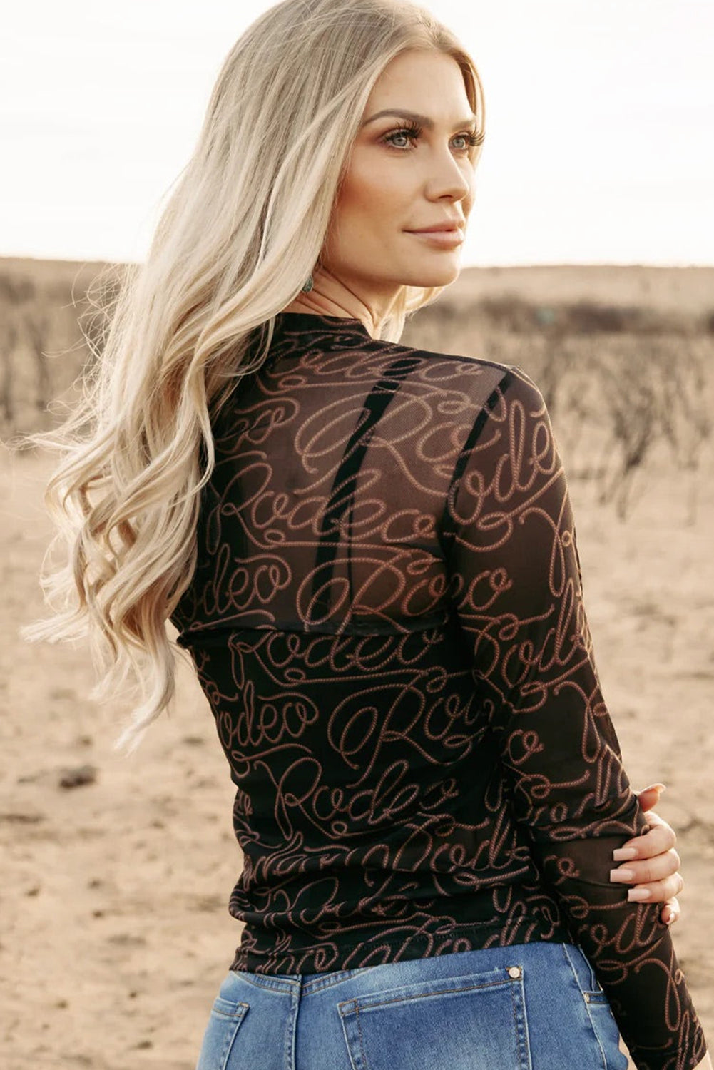 Rodeo chic: Black mesh long sleeve top with western print