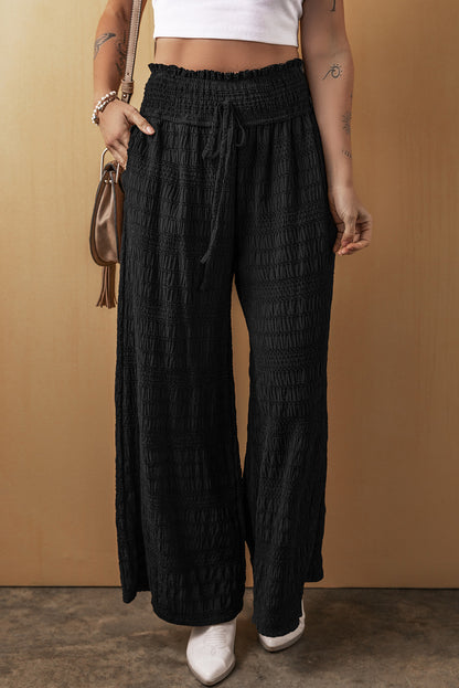 Relaxed black textured smocked waist wide-leg pants