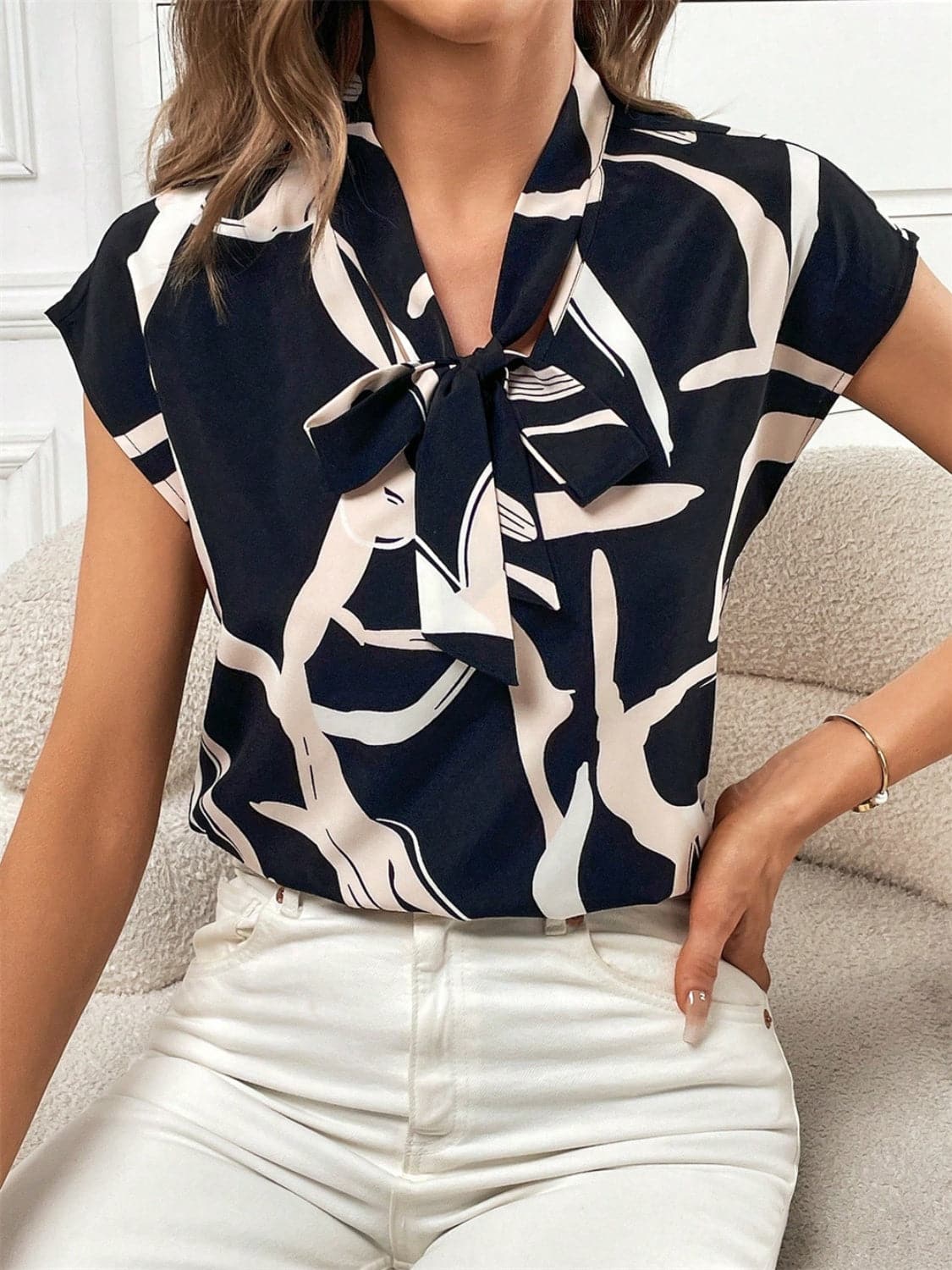 Printed Tie Neck Cap Sleeve Blouse.