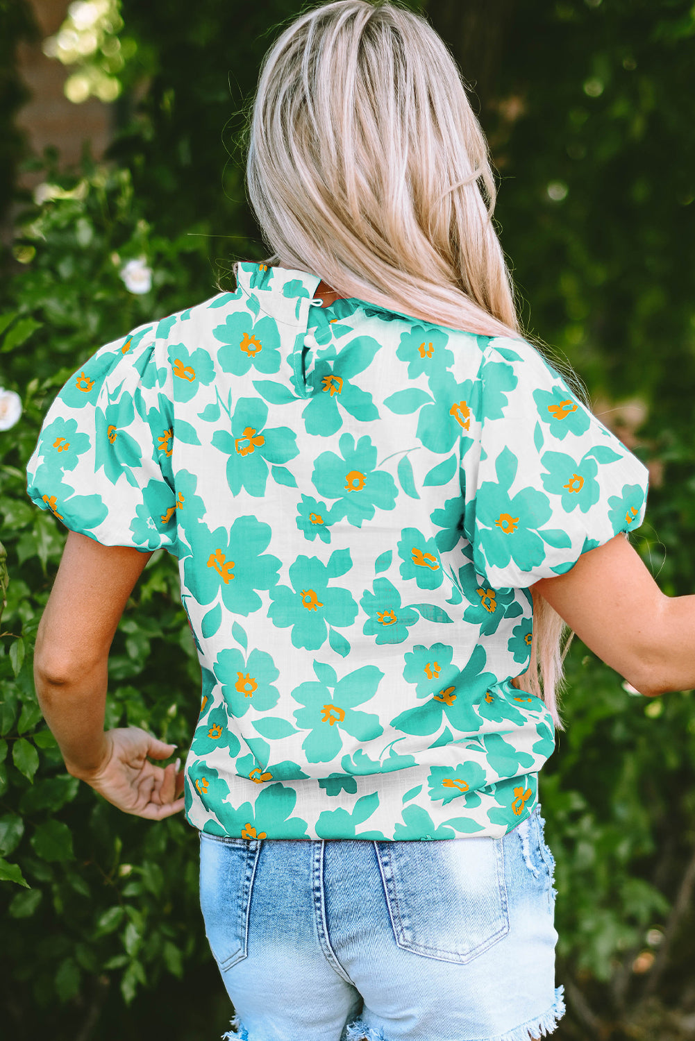 Chic green floral blouse with puff sleeves and frilled neckline