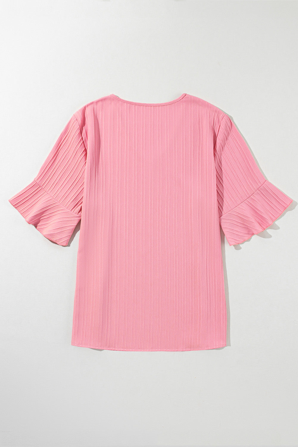 Peach blossom textured plus top with ruffled sleeves and V-neck