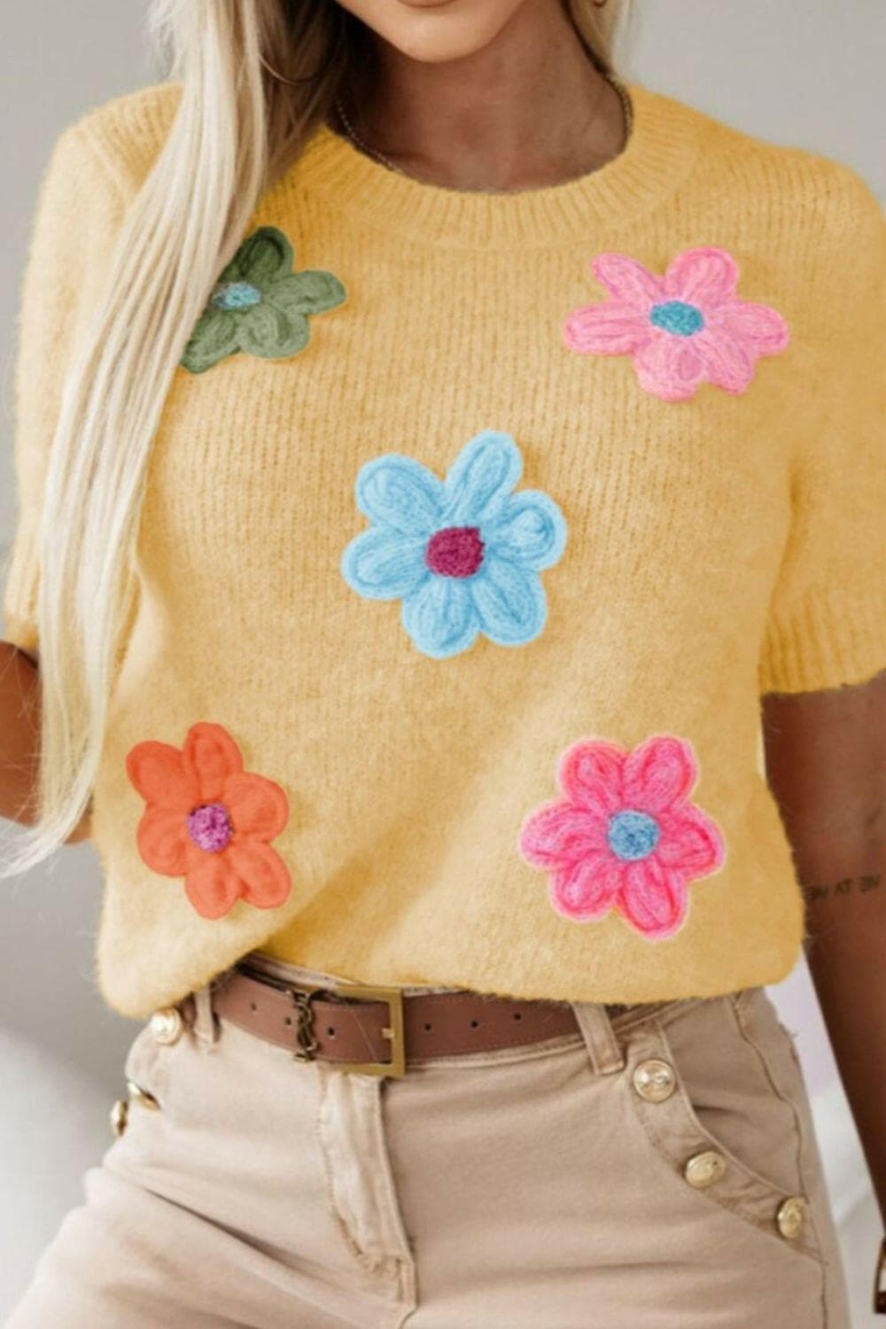 Floral round neck short sleeve sweater with colorful flower design.