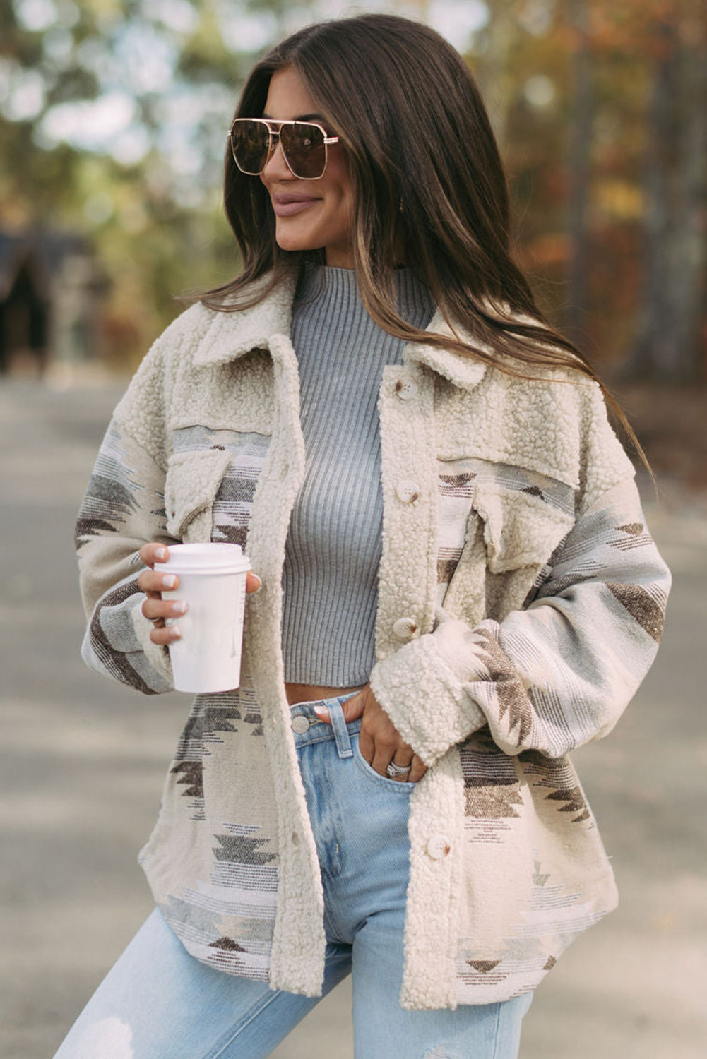 Khaki sherpa coat with vibrant Aztec print and flap pockets