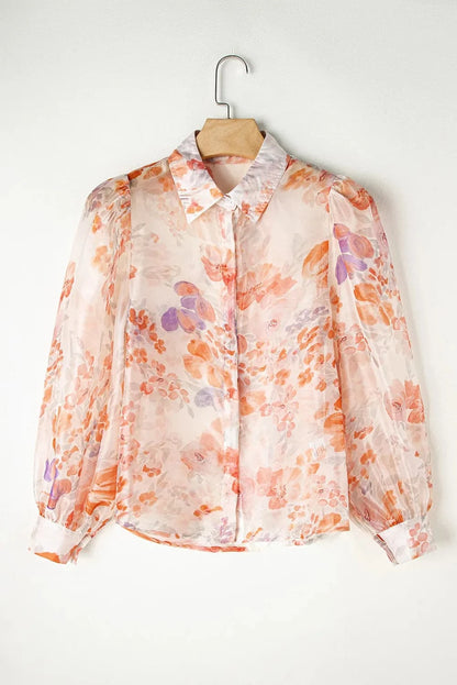 Trendy printed long sleeve shirt with floral design in orange and purple hues.