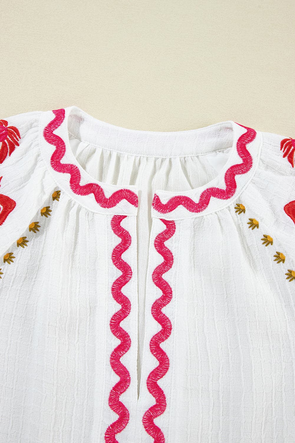 Embroidered Notched Half Sleeve Blouse.