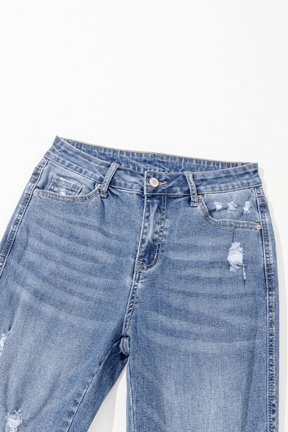 Dusk blue high-waisted flared jeans with distressed hem and ripped details