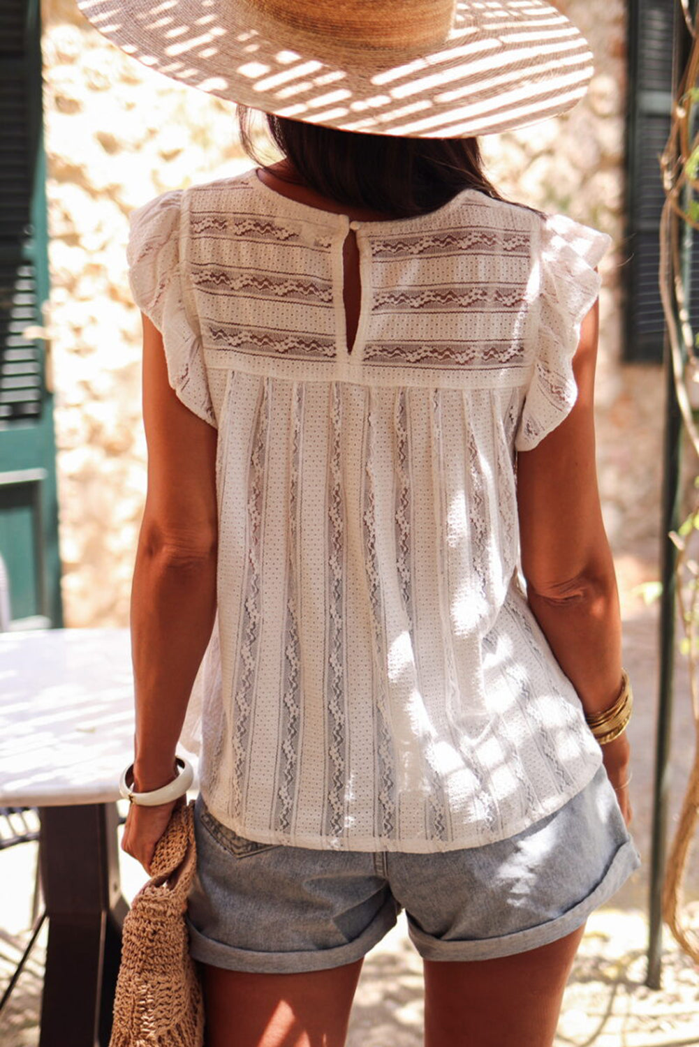 Lace-trimmed white flowy tank top with ruffled accents