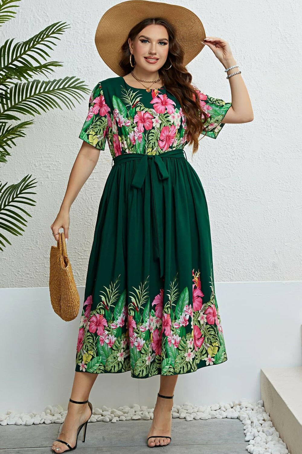 Floral midi dress with tie waist and round neck, featuring a vibrant pattern, flattering A-line hem, and delicate flutter sleeves.