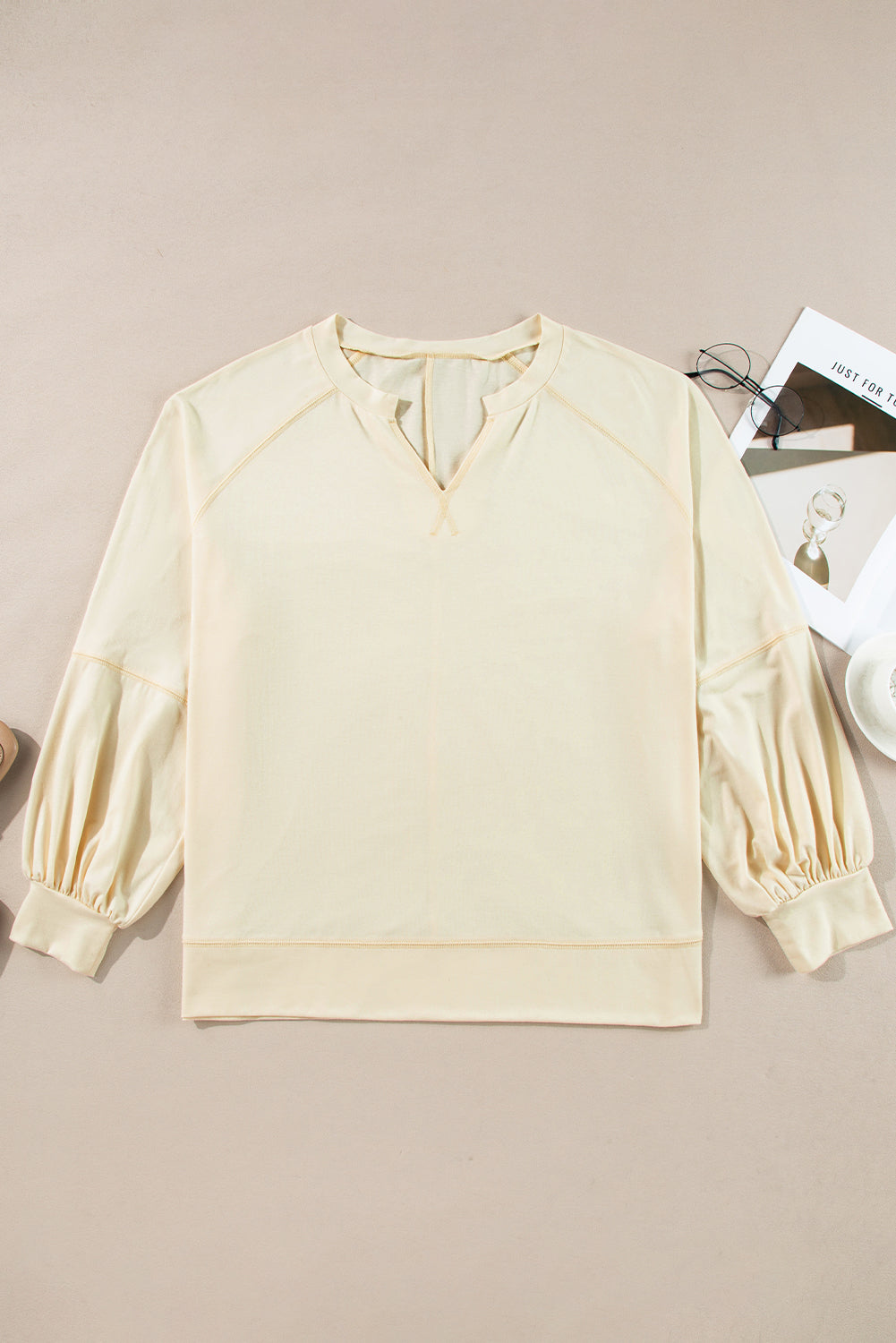 Chic apricot long sleeve top with notched neckline and exposed stitching