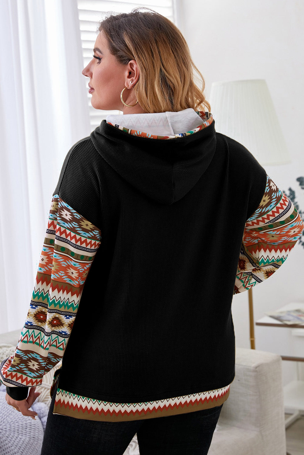 Stylish black hoodie with Aztec patchwork sleeves and drawstring detail