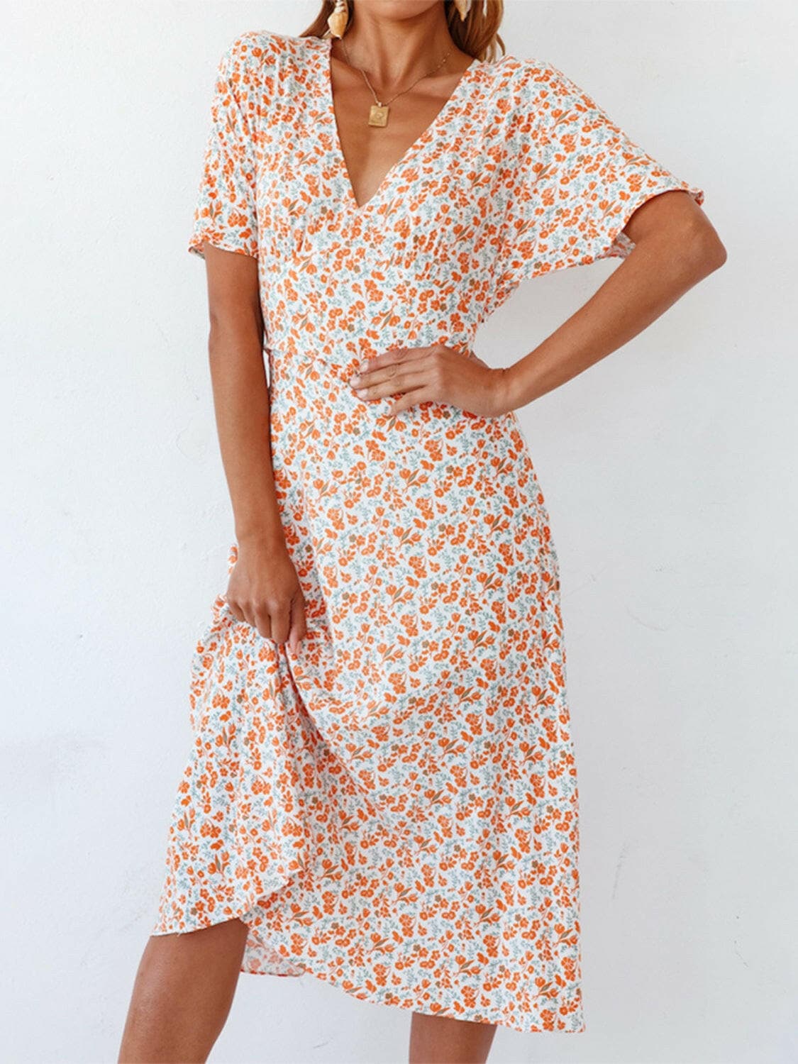 Ditsy Floral V-Neck Short Sleeve Midi DressDitsy Floral V-Neck Short Sleeve Midi Dress
 Embrace your femininity with the timeless elegance of the Ditsy Floral V-Neck Short Sleeve Midi Dress.
 Main Features:
 Love Salve -Neck Short Sleeve Midi Dressswimwear