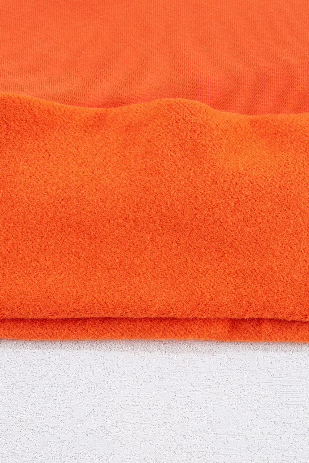 Cozy russet orange fleece-lined sweatshirt with drop shoulders