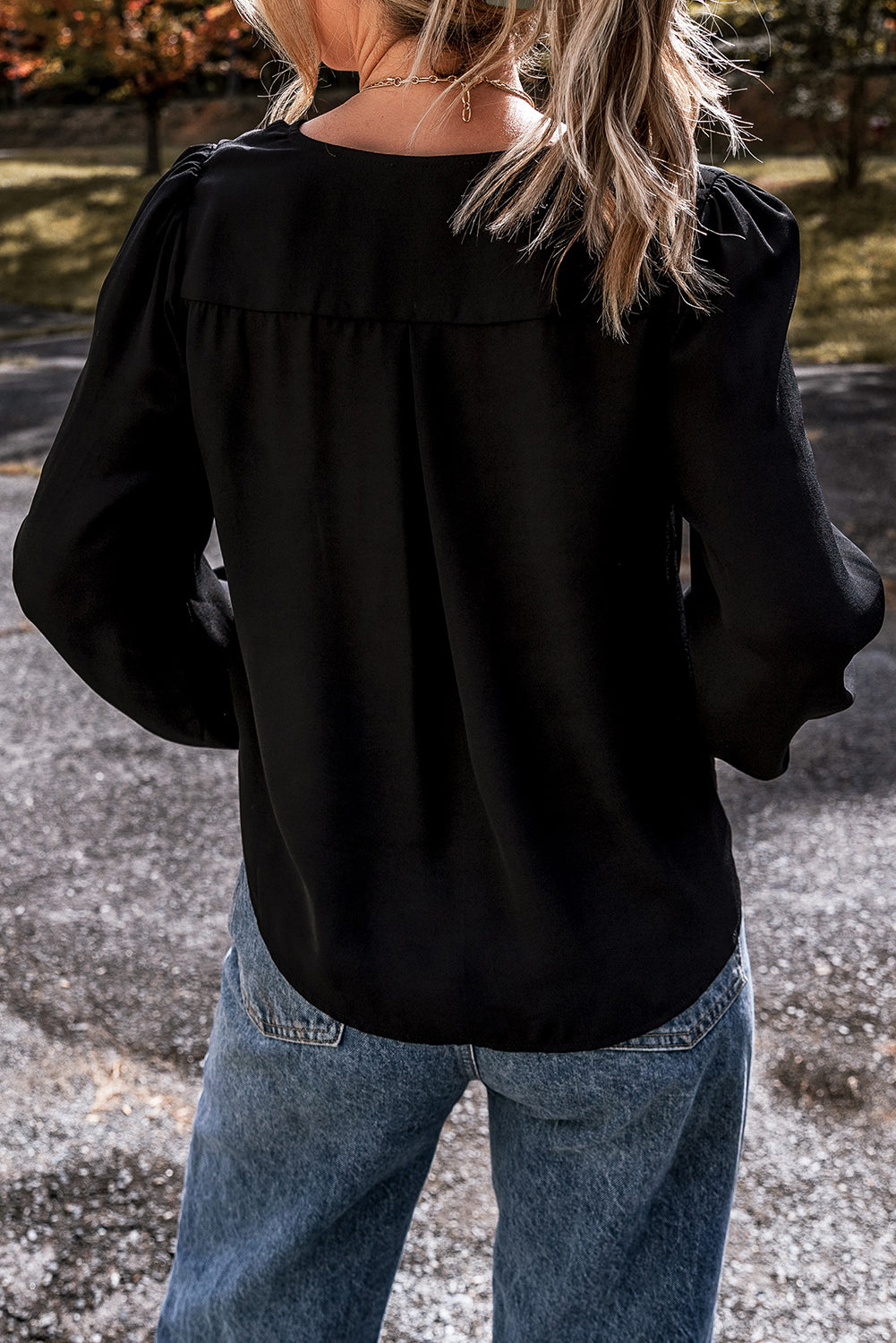 Elegant black lace V-neck blouse with crochet cuffs