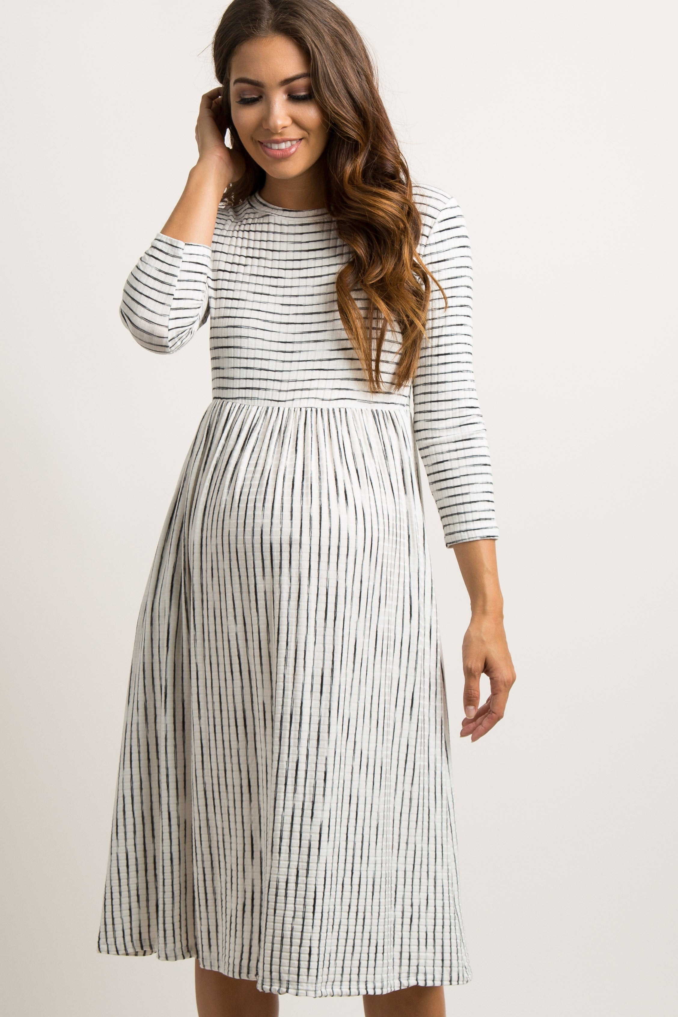 PinkBlush Ivory Ribbed Striped Maternity Midi Dress, side profile, highlighting the flattering ribbed fabric and chic materni