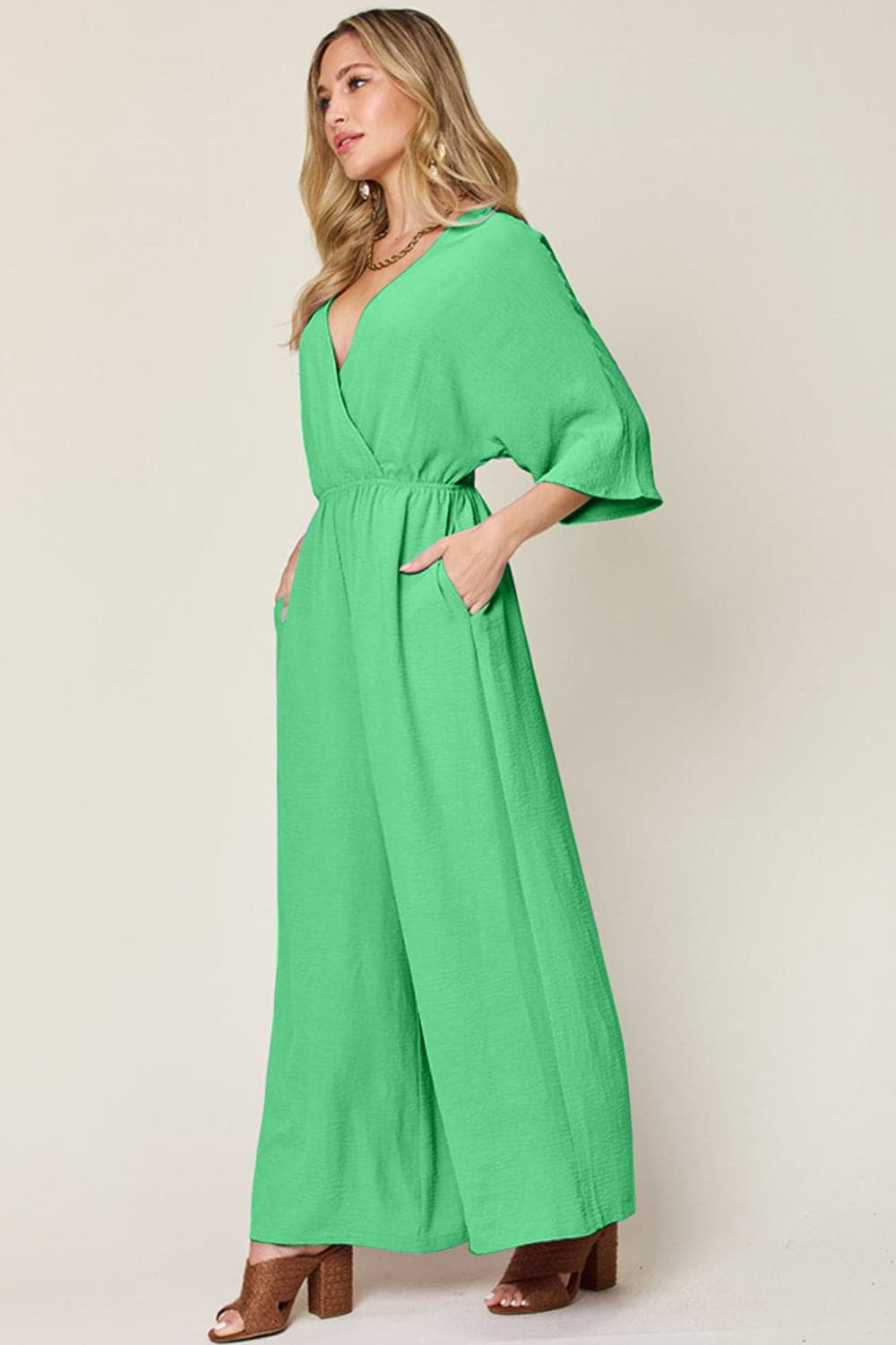 Double Take Full Size Surplice Wide Leg Jumpsuit with Pockets.