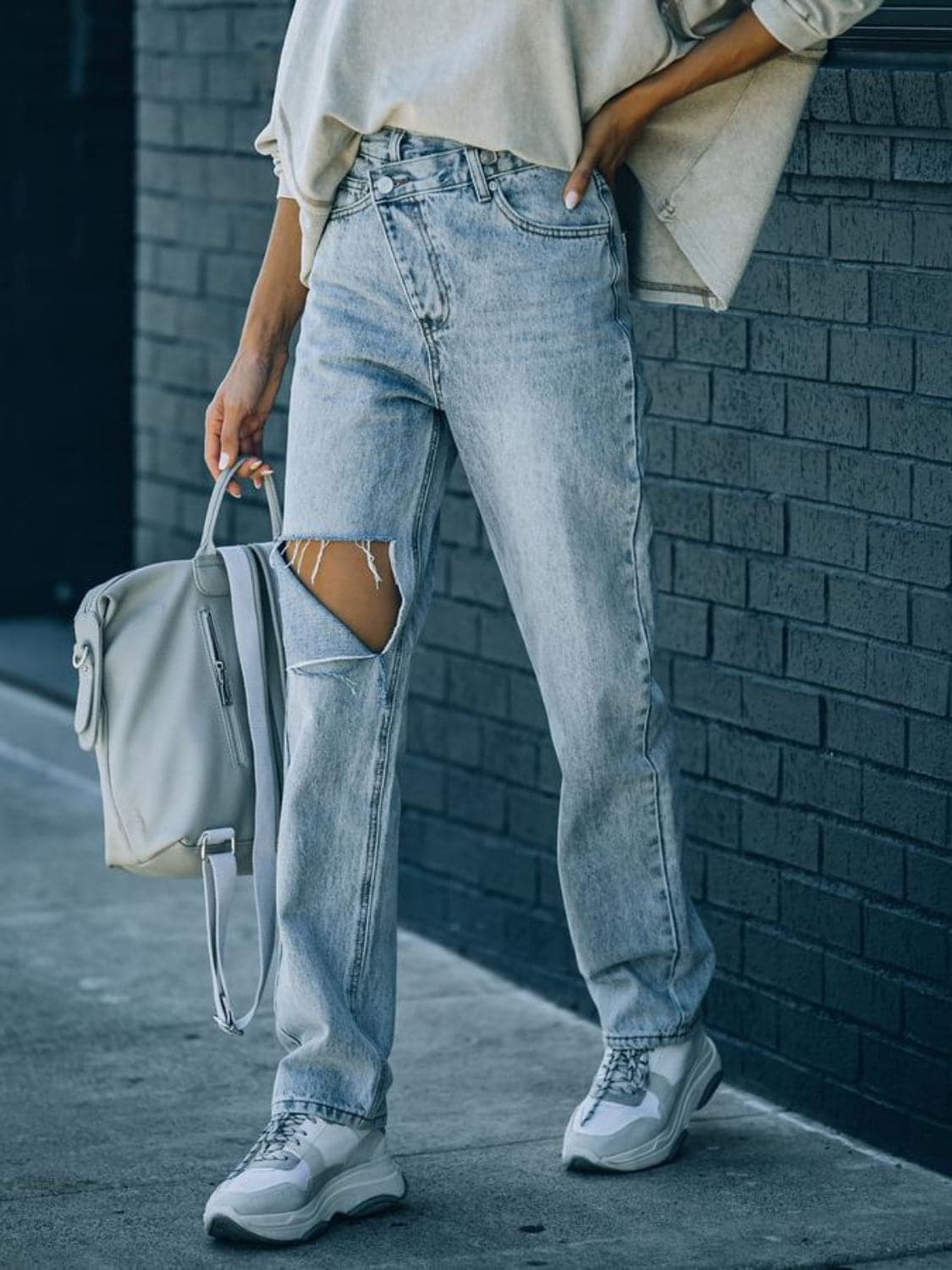 Distressed Asymmetric Waist Jeans.