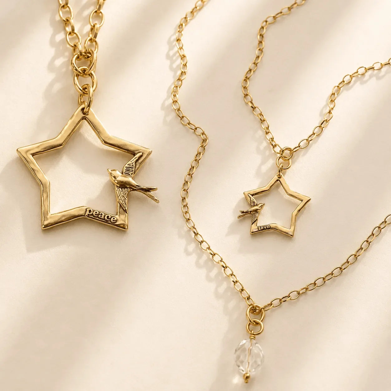 Katia Designs Peace & Love Star and Bird Original Lite Necklace displayed on a neutral background, emphasizing its craftsmans