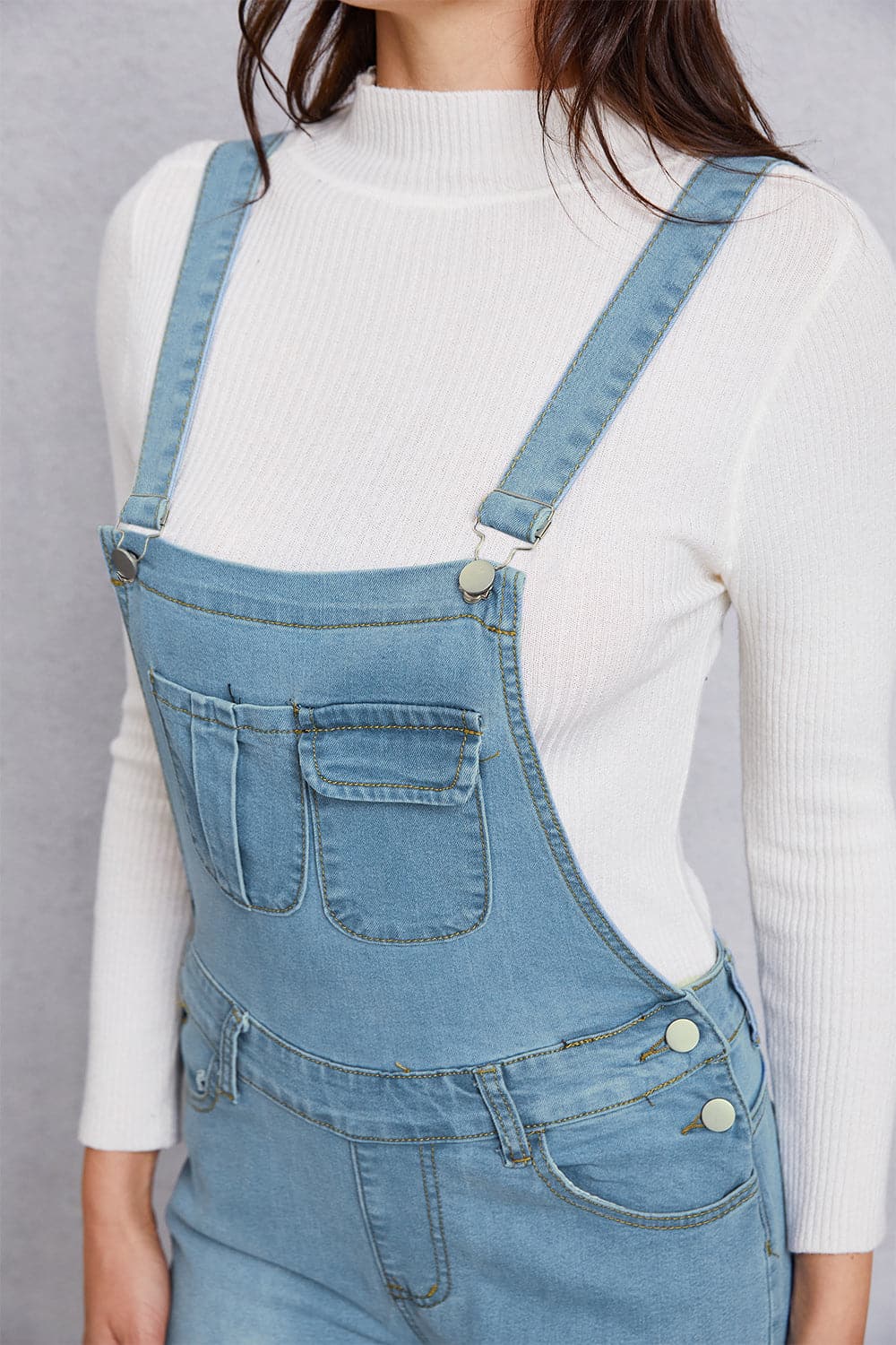 Distressed Washed Denim Overalls with Pockets.