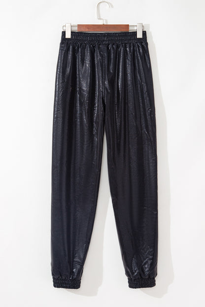 Trendy black high-waisted joggers with pockets and pebble print