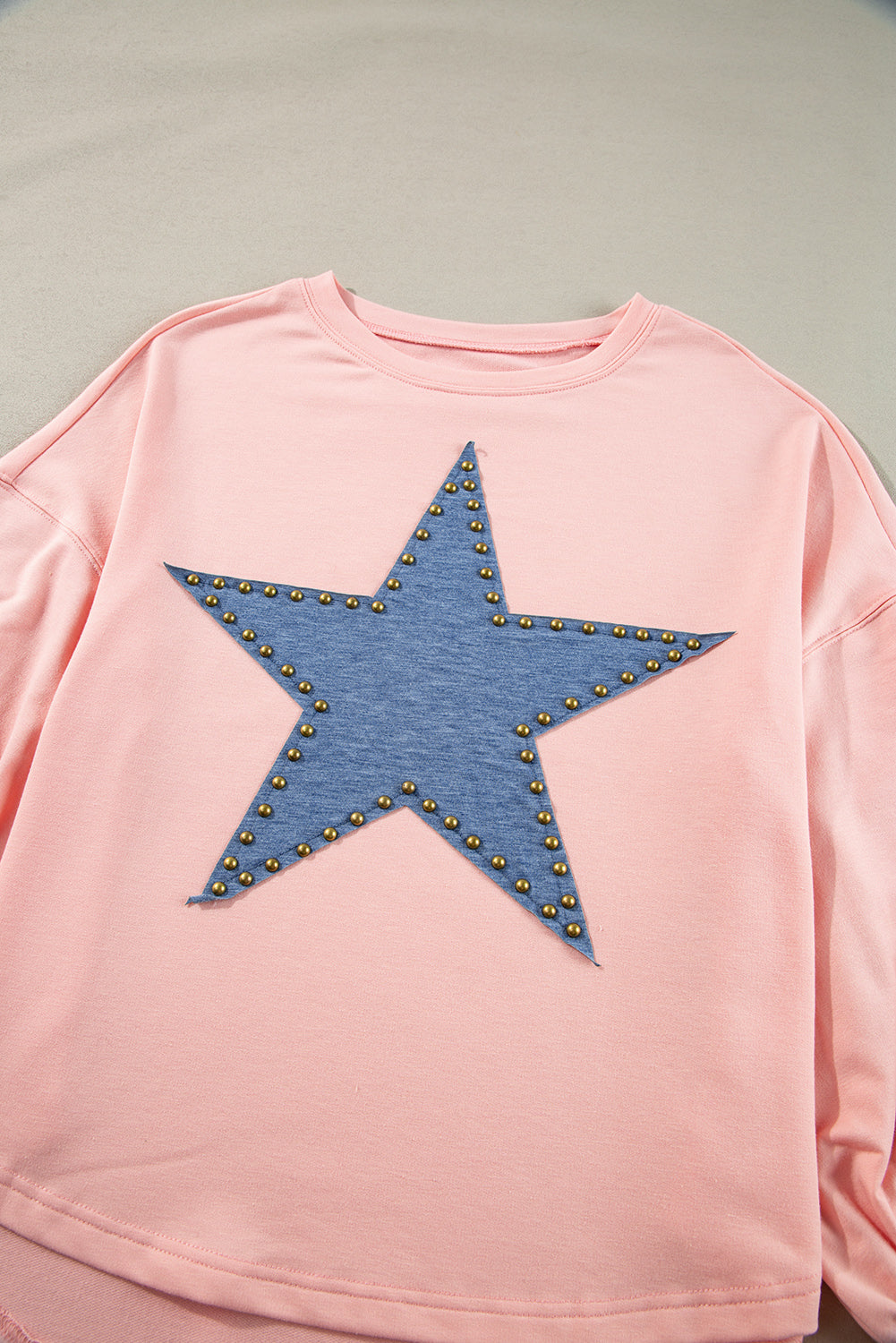 Celestial chic: Gossamer pink oversized long sleeve top with star graphic and studs