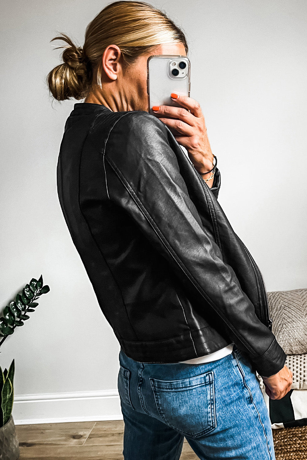 Sleek black faux leather bomber jacket with trendy zipper details