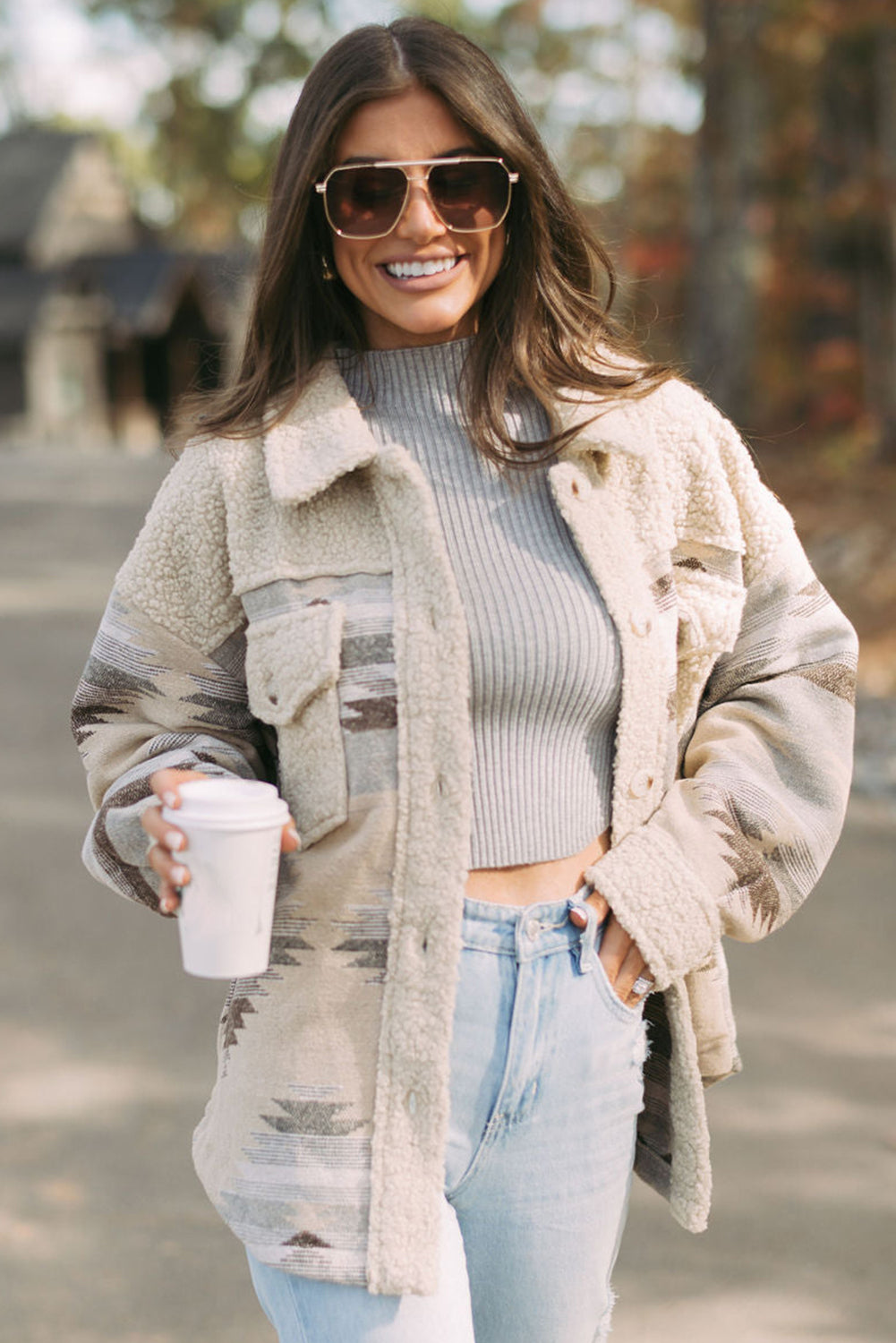 Khaki sherpa coat with vibrant Aztec print and flap pockets