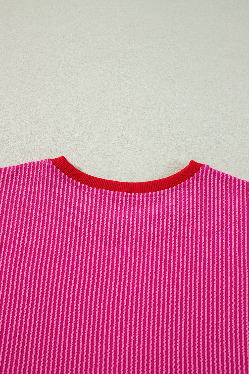 Vibrant pink corded edge drop shoulder long sleeve top