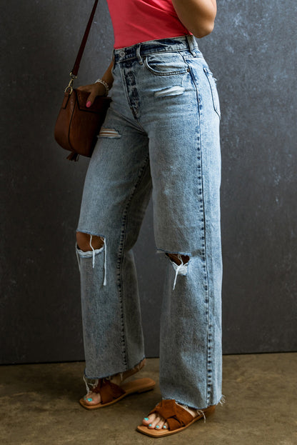 Trendy light blue distressed straight leg jeans with raw hem